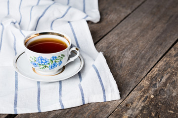 Cup of black tea in a china cup and saucer