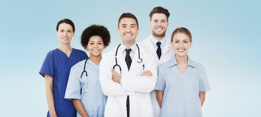 group of happy doctors over blue background