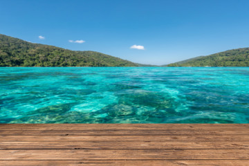 Poster - wooden floor with beautiful ocean and blue sky scenery