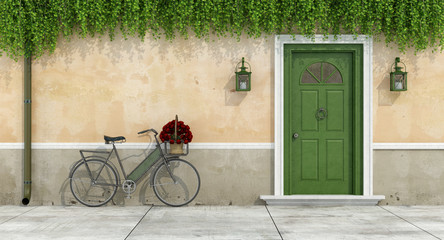 Country house with old door and bicycle