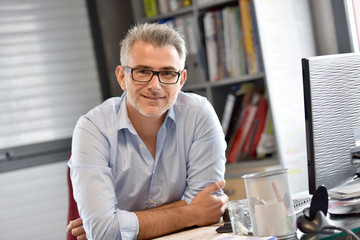 Portrait of businessman sitting in office