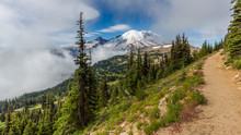 Amazing View At The Snowy Peaks Which Rose Against The Blue Of A Cloudless Sky. Narrow Rocky Trail High In The Mountains. MOUNT FREMONT LOOKOUT TRAIL, Sunrise Area, Mount Rainier