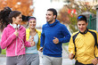© BalanceFormCreative - A lively group of young friends enjoys a refreshing jog in the park during the vibrant autumn season, relishing the camaraderie and the crisp, cool air.
