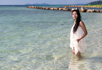 Wall Mural - woman in a white dress in the sea