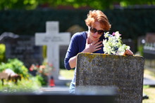 Mourning/ Woman Mourning A Deceased Loved One On A Graveyard