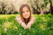 © mashiki - summer outdoor close up portrait of beautiful happy kid girl lying on the grass in park