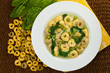 Tortellini Soup with Peas and Spinach. Selective focus.