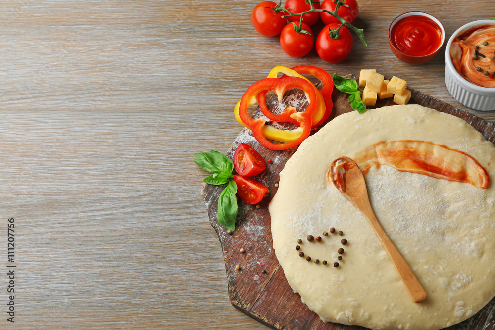 Fresh ingredients for pizza preparing on wooden table, close up