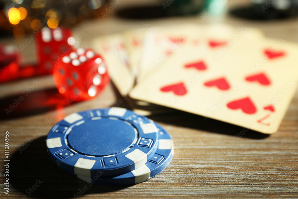 Set to playing poker with cards and chips on wooden table closeup