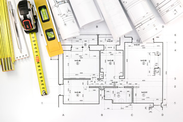 Poster - rolls of architectural blueprints and house plan with engineerin