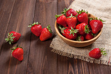 Fresh Strawberries On An Old Wooden Surface.