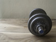 © chaowalit - metal dumbbell on a old wooden background