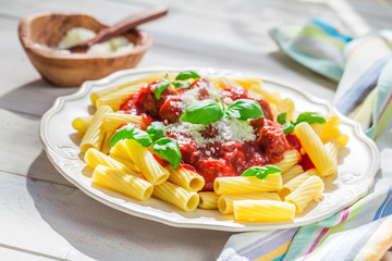 Wall Mural - Homemade pasta penne with tomato sauce, basil and parmesan