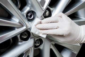 Wall Mural - Car detailing series : Closeup of hand coating car wheel