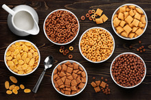 Collection Of Breakfast Cereal On A Wooden Background. Cornflake