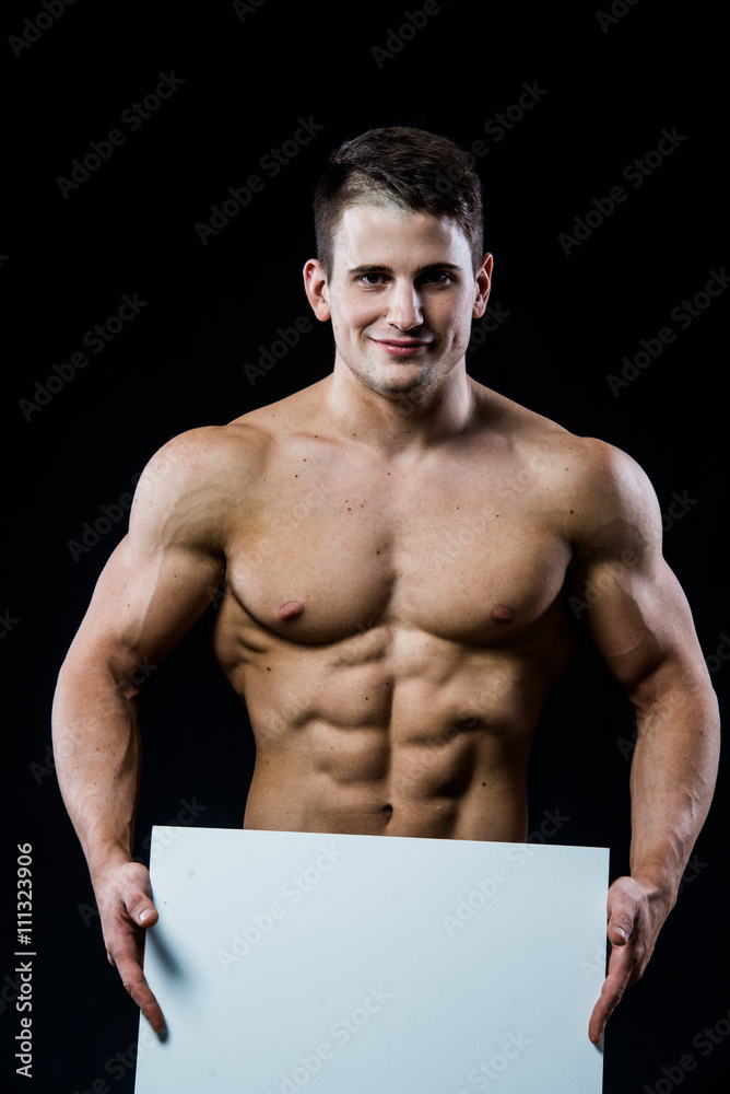 Full isolated studio picture from a young naked man with white sign
