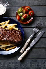 Sticker - Grilled steak with french fries and vegetables, closeup