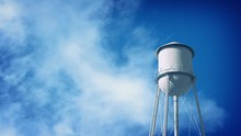 Water Tower With Clouds Passing