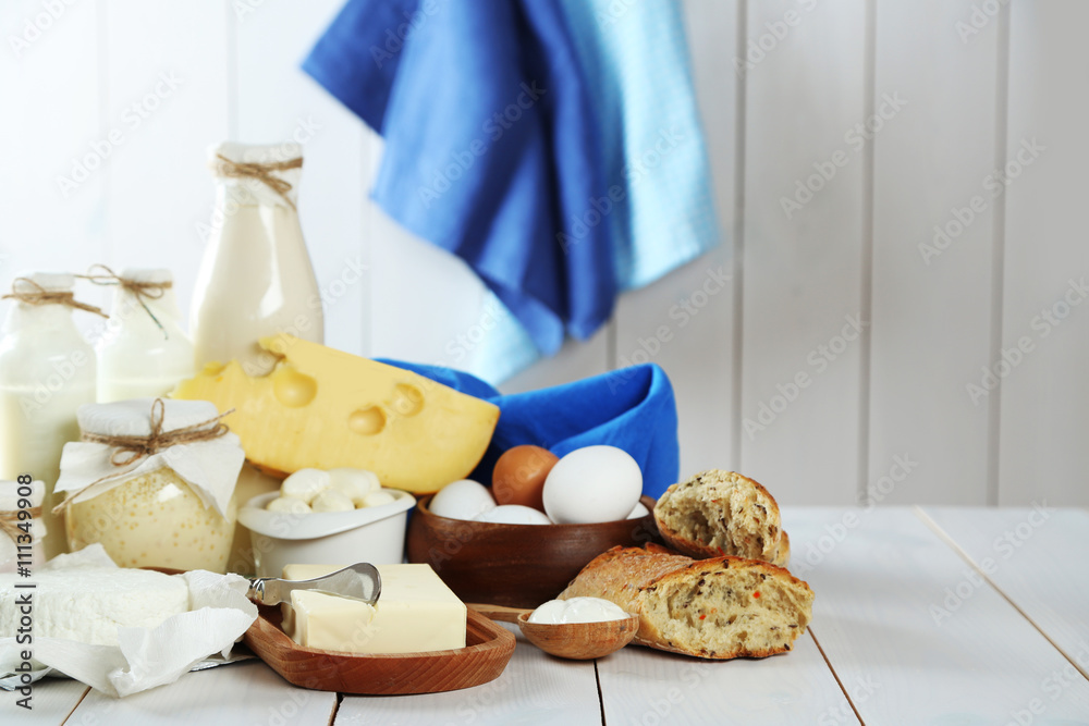 Set of fresh dairy products on white wooden table