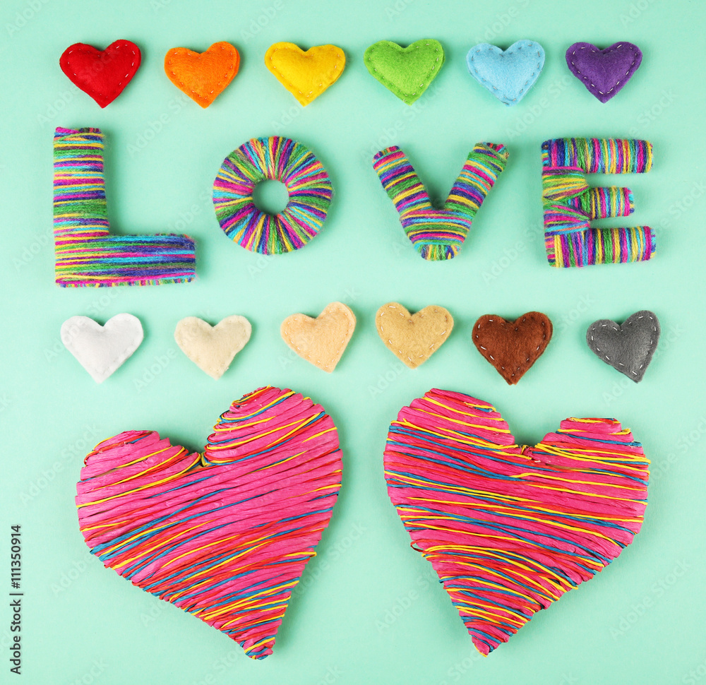 Valentine's Day concept. Handmade hearts and word LOVE on turquoise background