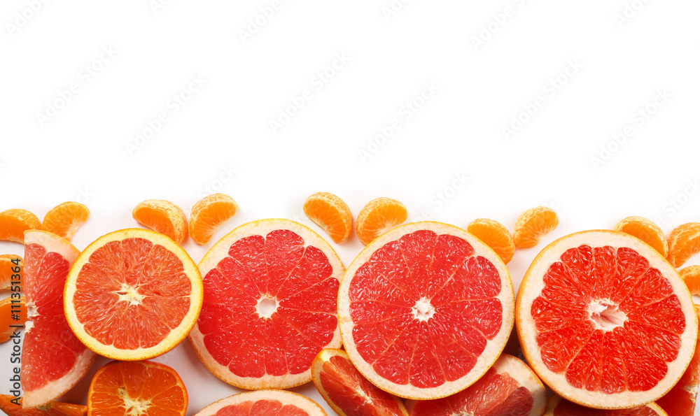 Fresh mixed citrus fruit including   grapefruits, oranges and tangerines with slices isolated on white background, top view