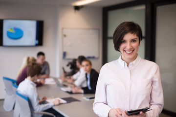 Wall Mural - hispanic businesswoman with tablet at meeting room