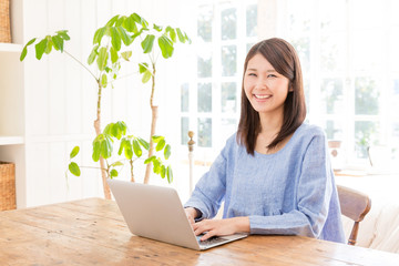 Wall Mural - young asian woman using laptop