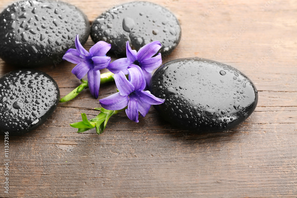 Heap of spa hot stones on wooden table