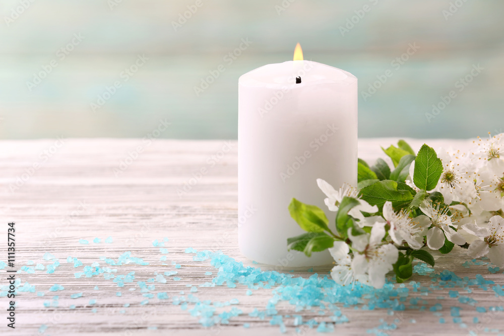 Spa composition with blooming branches on wooden table