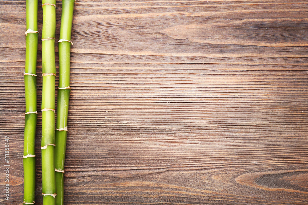 Bamboo branches on wooden background