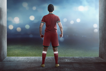 Back view of asian football player standing