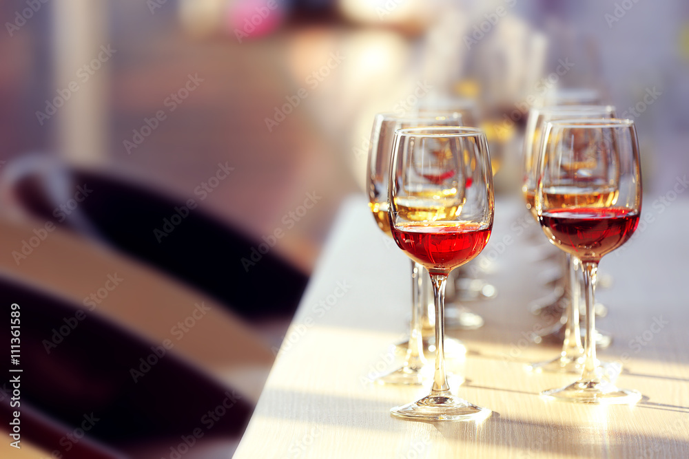 Many glasses of different wine in a row on a table