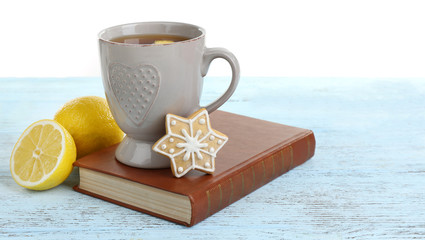 Fototapete - Beautiful winter composition with cup of hot drink, on wooden table with white background