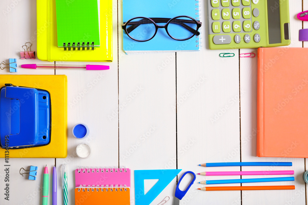 Flat lay of stationery on white wooden table background, copy space