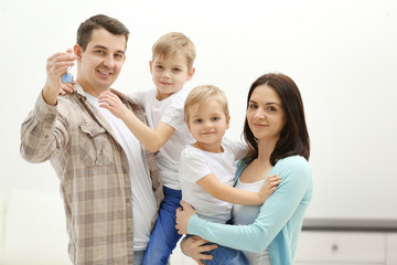 Happy family with key in new house, indoor