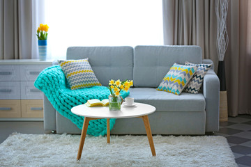 Wall Mural - Yellow narcissus on white table in room interior