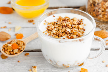 Wall Mural - yogurt with homemade granola, nuts and dried fruits in a glass cup