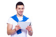 © HBS - Examining his brand new gadget. Handsome young man holding digital tablet and looking at it with smile while standing against white isolated background