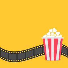 Popcorn. Film strip border. Red yellow box. Cinema movie night icon in flat design style. Yellow background.