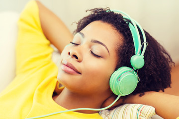 Wall Mural - happy woman with headphones listening to music