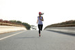young fitness woman runner running on road