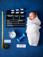 Wall Mural - newborn baby lying on blue blanket next basic data