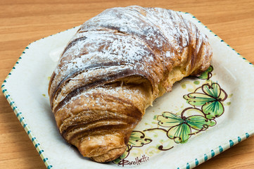 Croissant in colored dish