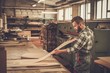 © Nejron Photo - Carpenter doing his job in carpentry workshop.