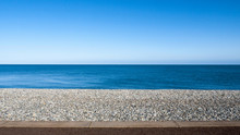 Seascape With Pebble Stone Beach And Sea Defence Wall On A Beautiful Day In Llandudno Wales UK