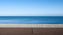 Seascape With Pebble Stone Beach And Sea Defence Wall On A Beautiful Day In Llandudno Wales UK