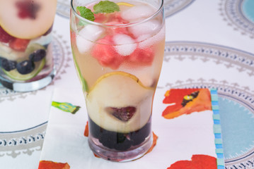 Wall Mural - Glasses of fruit and berries, mint infused water with ice.