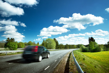 Canvas Print - Car on asphalt road in beautiful spring day at countryside