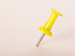 © laboko - Yellow pushpin on  light pink background.