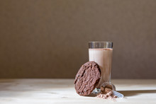 Closeup Of Freshly Baked Protein Cookies On The Wooden Background Next To A Glass Of Protein And Scattered On The Table The Protein From The Spoon, Scoop